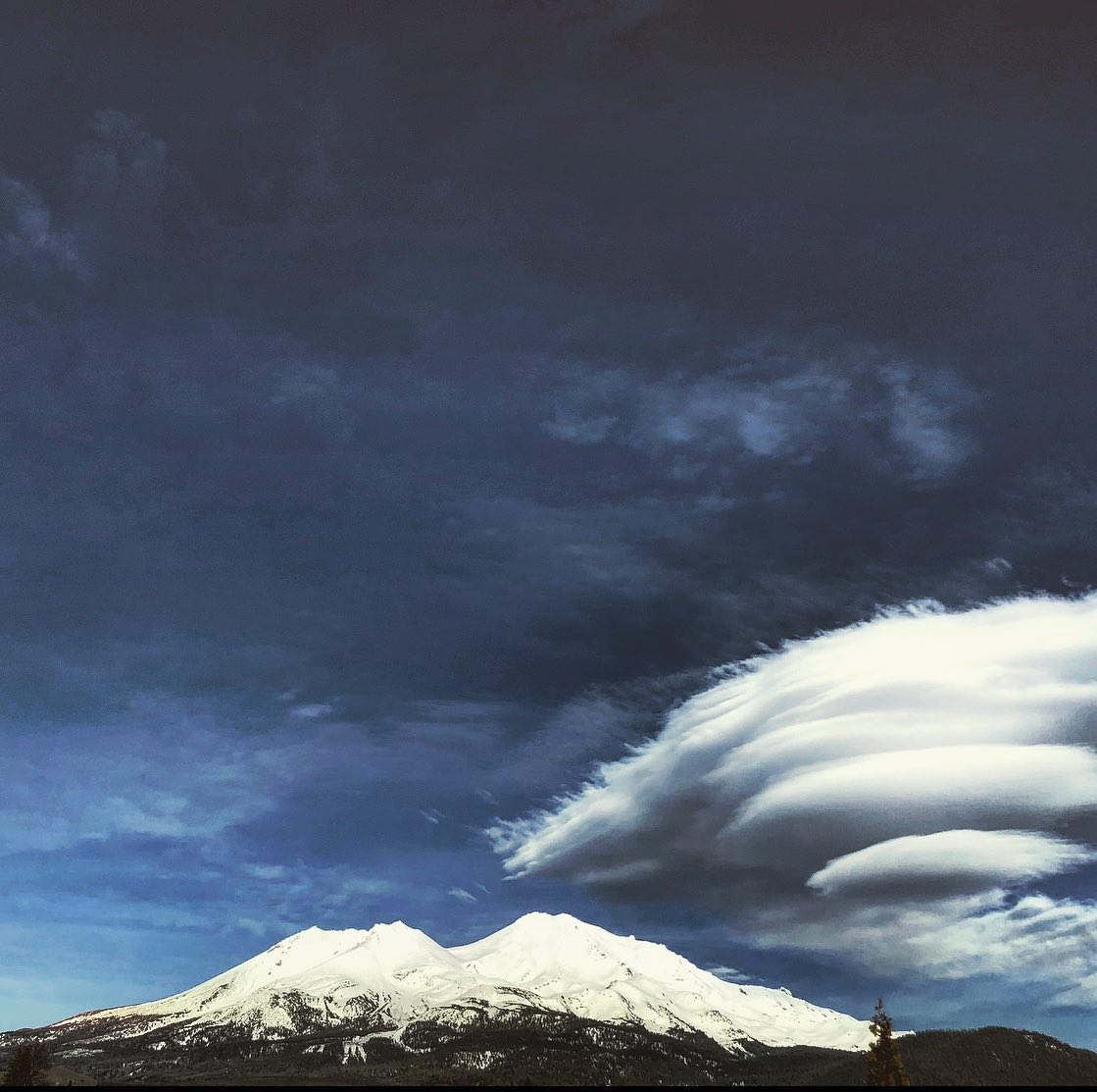 Mount Shasta under a dramatic stacked lenticular cloud, snow on the peak